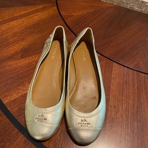 Slightly used gold Coach slip on loafers